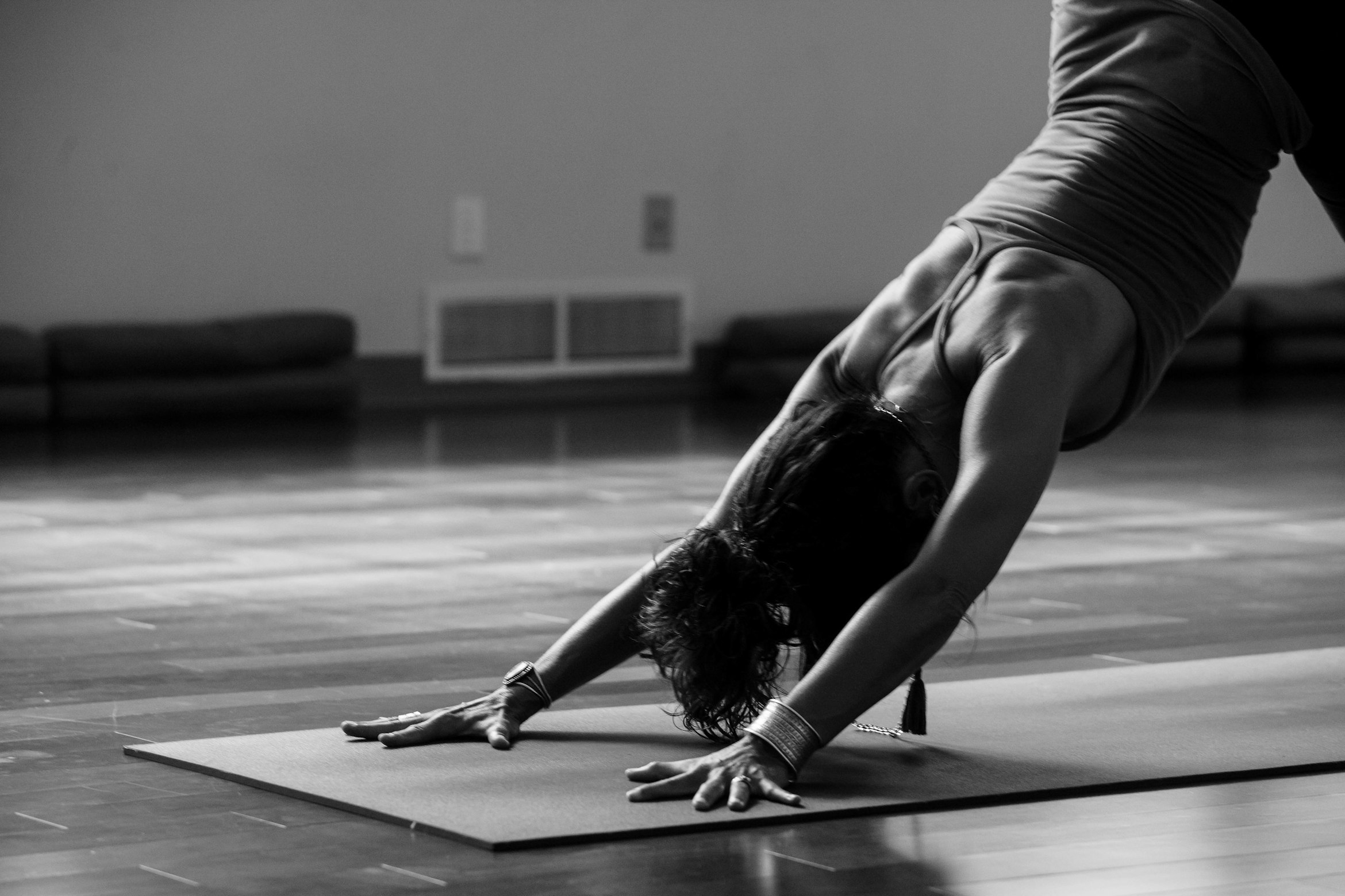 Senior yoga teacher David Chen demonstrating advanced pose
